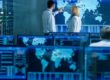 people working in a control room with monitors | security operations center