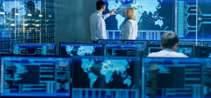 people working in a control room with monitors | security operations center