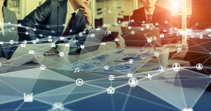 two men sitting at board room table