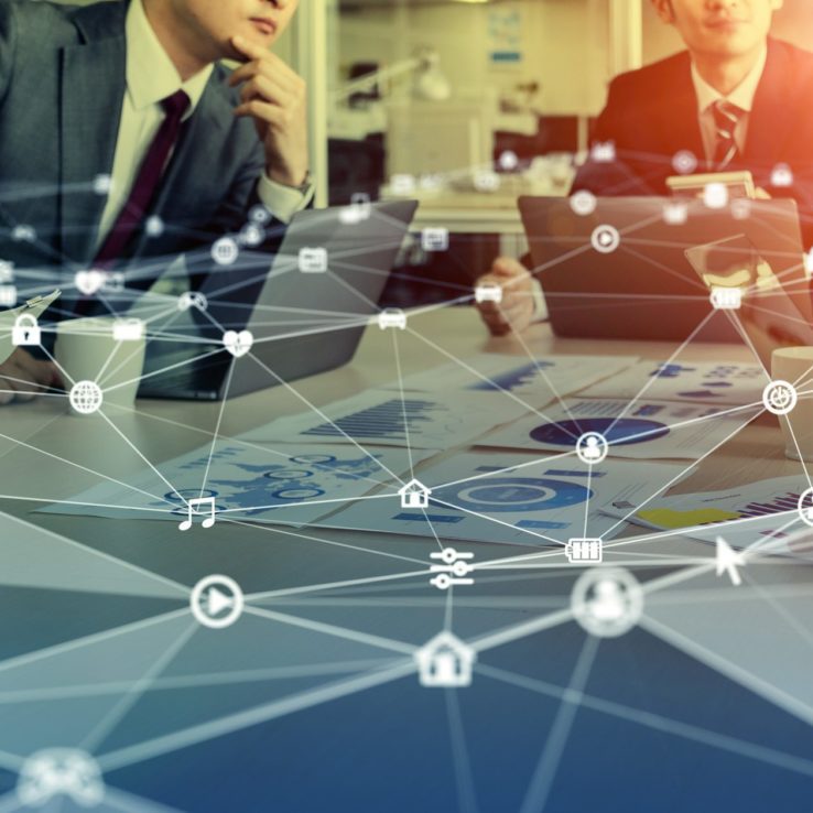 two men sitting at board room table