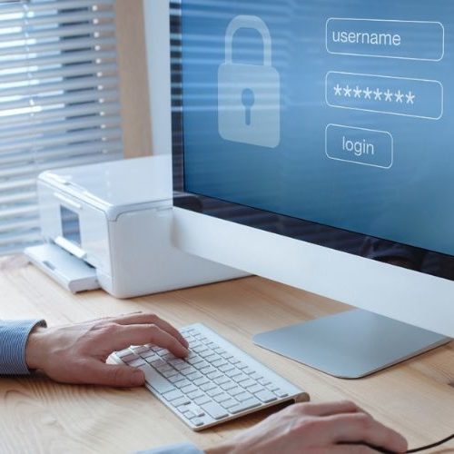 man at a desktop logging in his password