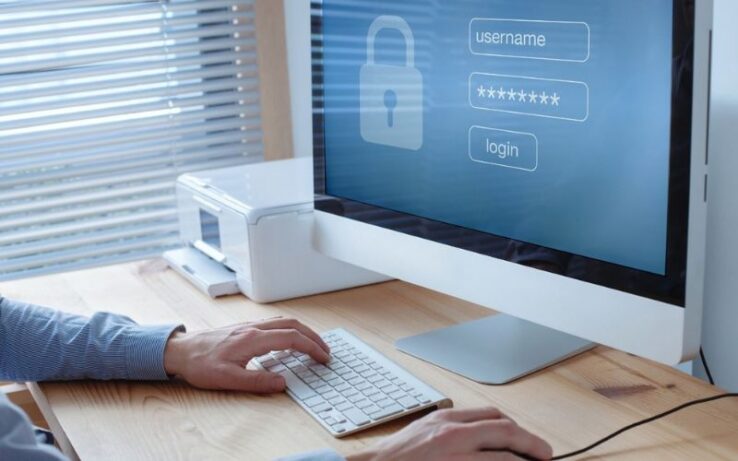 man at a desktop logging in his password