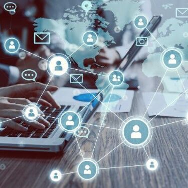 people sitting side by side on laptops with social media icons around them