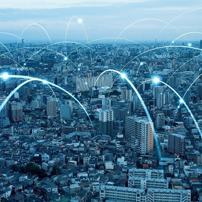 city with beams of light going from building to building