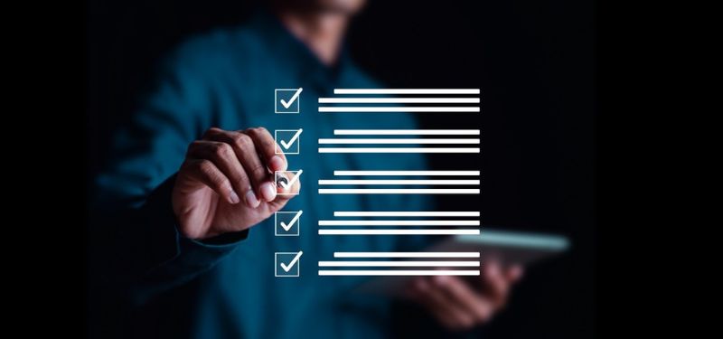 a man checking things off a screen