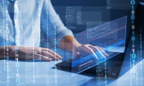 man using a laptop with code coming down the in the foreground