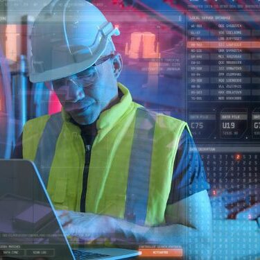 supervisor wearing heard hat and vest monitoring job site