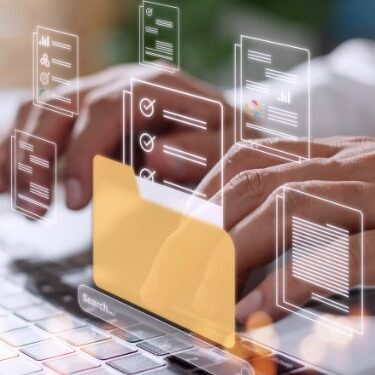 man typing on a laptop