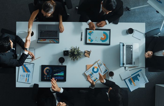 overhead shot of a conference table with people sitting at it 