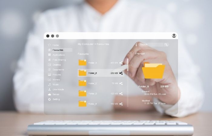 person sitting behind a transparent screen, image of file sharing taking place