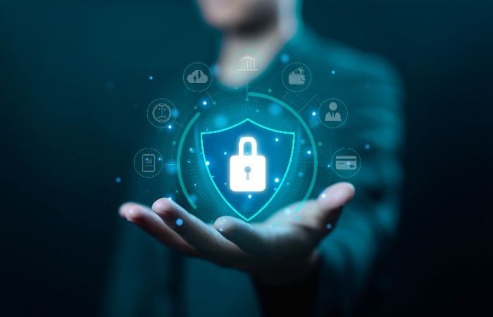 A man with a hand held out in front of him with a shield image in the palm of his hand 