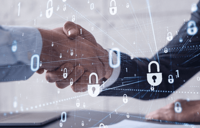 two hands shaking with locks in the foreground 